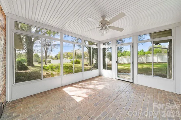 a view of an empty room with wooden floor and a sliding door