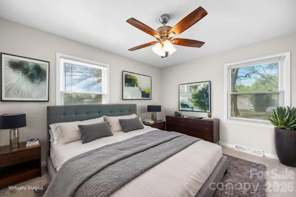 a bedroom with a large bed and a window