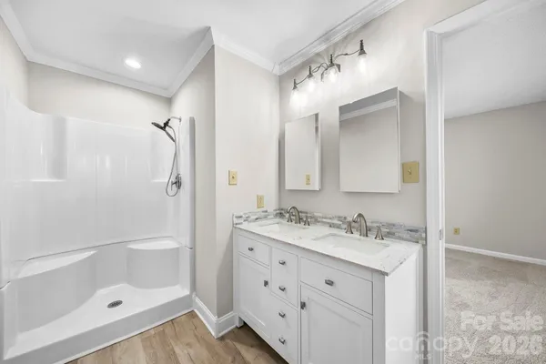 a bathroom with a sink vanity granite tub and shower