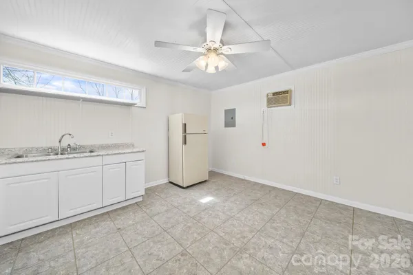 a view of a kitchen with sink and cabinet