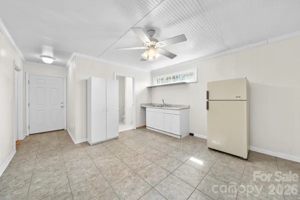 a view of kitchen with refrigerator and microwave