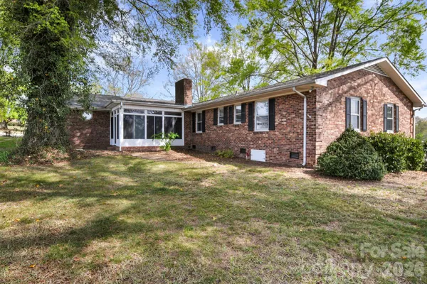 a front view of a house with yard and green space