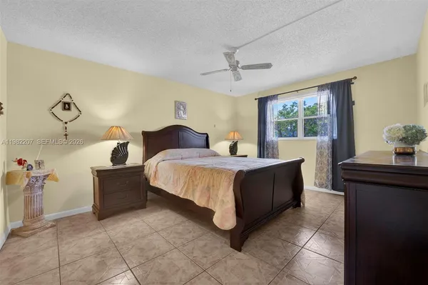 a spacious bedroom with a bed and wooden floor