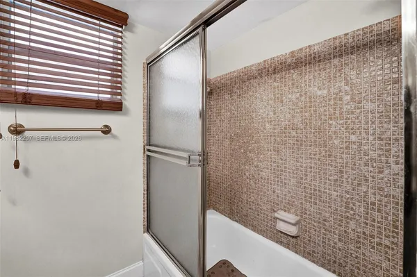 a bathroom with a shower and a sink