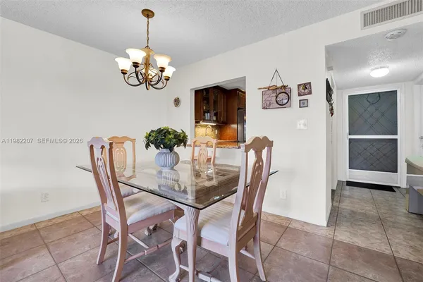 a dining room with furniture and chandelier