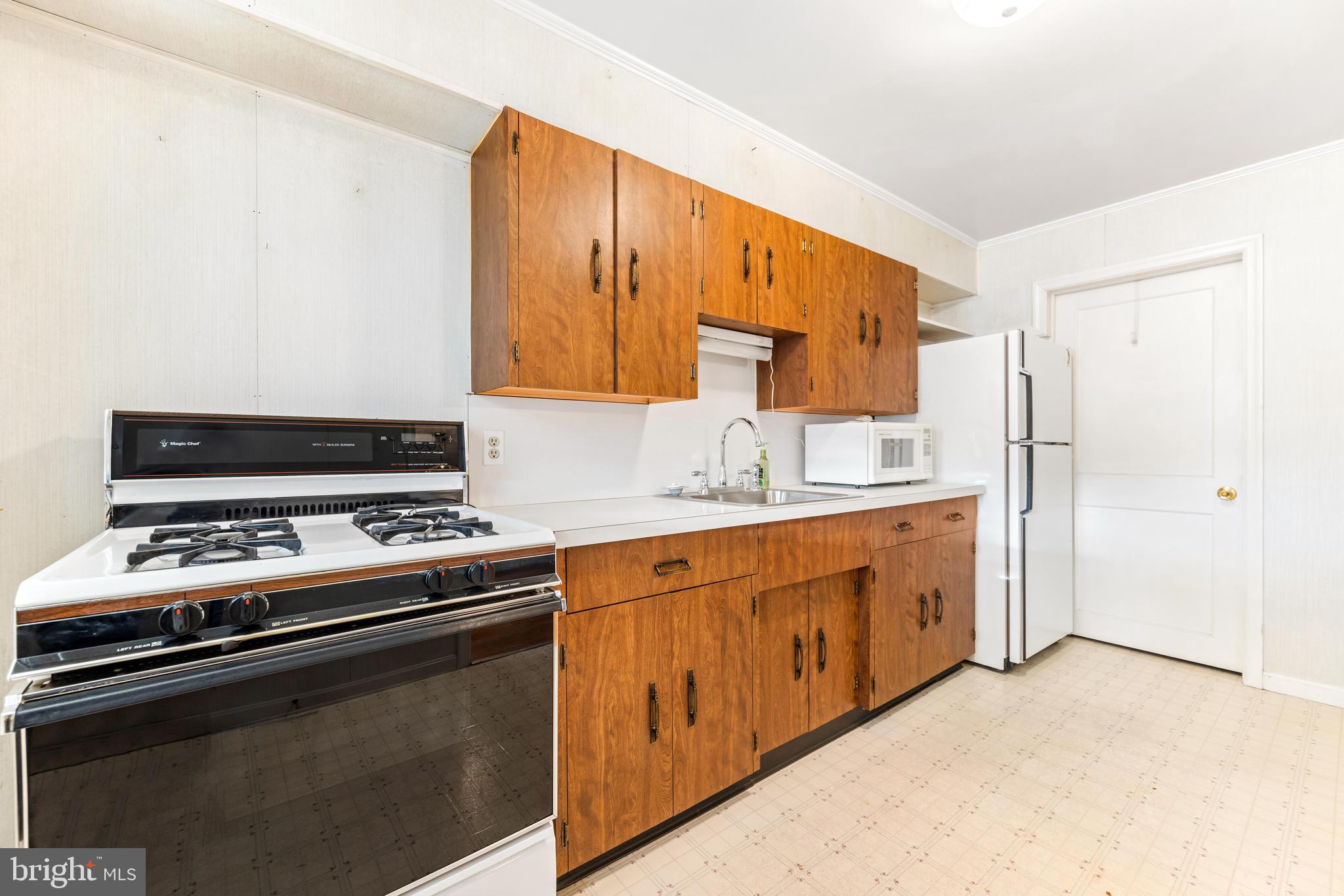 2245 Searles Road Baltimore, MD 21222 - Photo 10 of 33 a kitchen with stainless steel appliances a stove a sink and a refrigerator