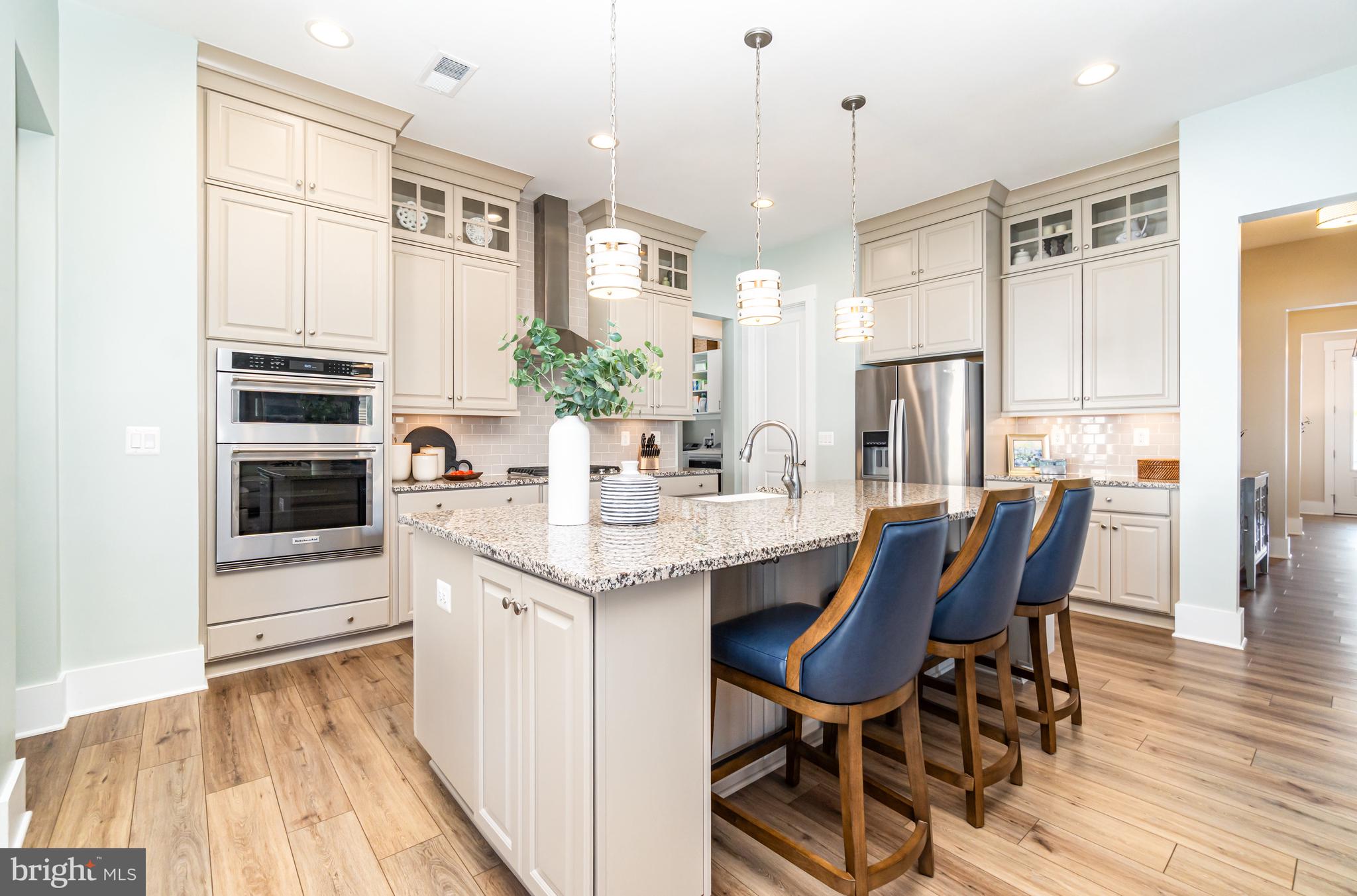 173 Lively Stream Way Gettysburg, PA 17325 - Photo 14 of 59 a kitchen with granite countertop a table chairs stove and cabinets