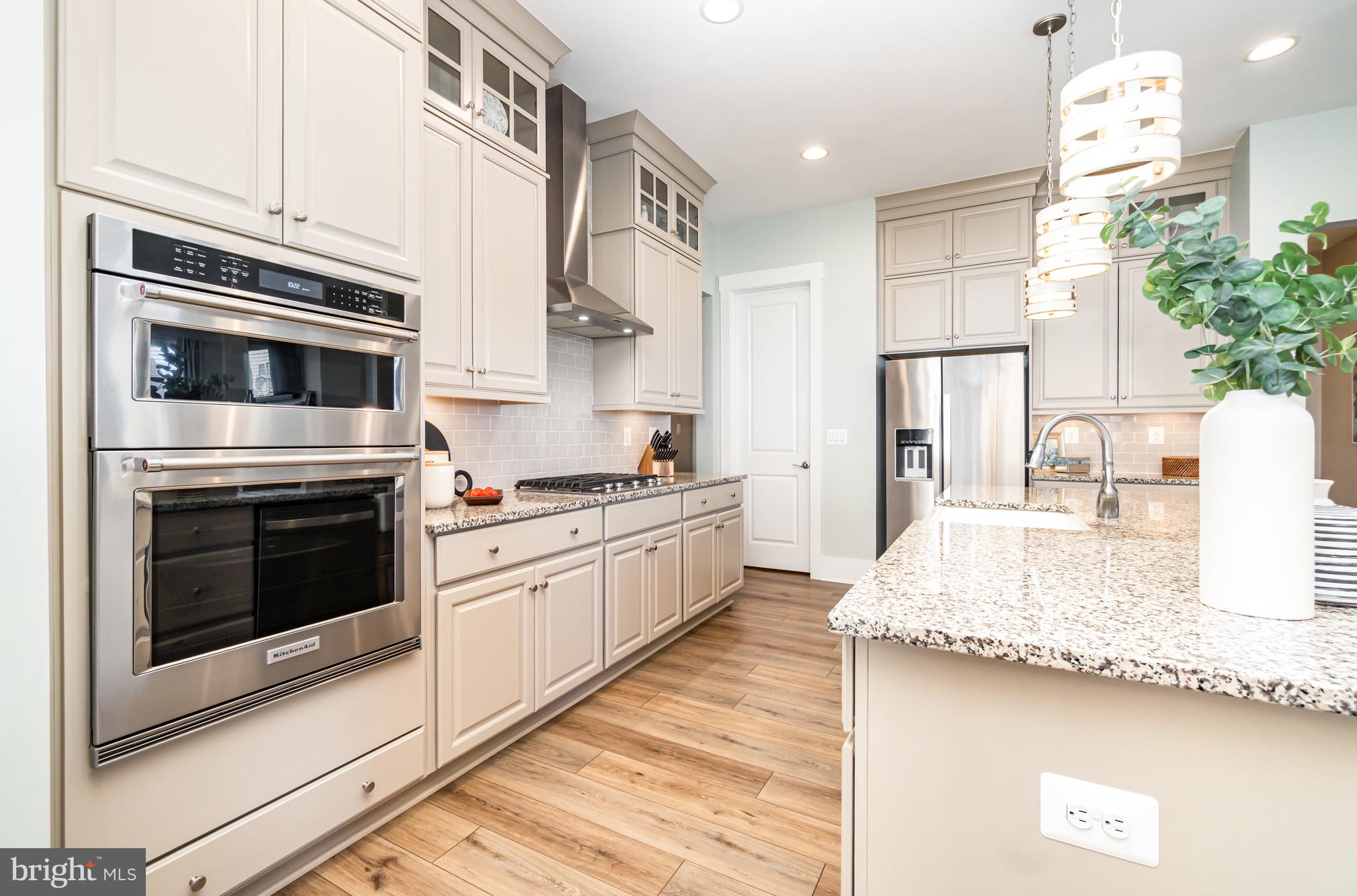 173 Lively Stream Way Gettysburg, PA 17325 - Photo 16 of 59 a kitchen with stainless steel appliances kitchen island granite countertop a stove a sink and a refrigerator