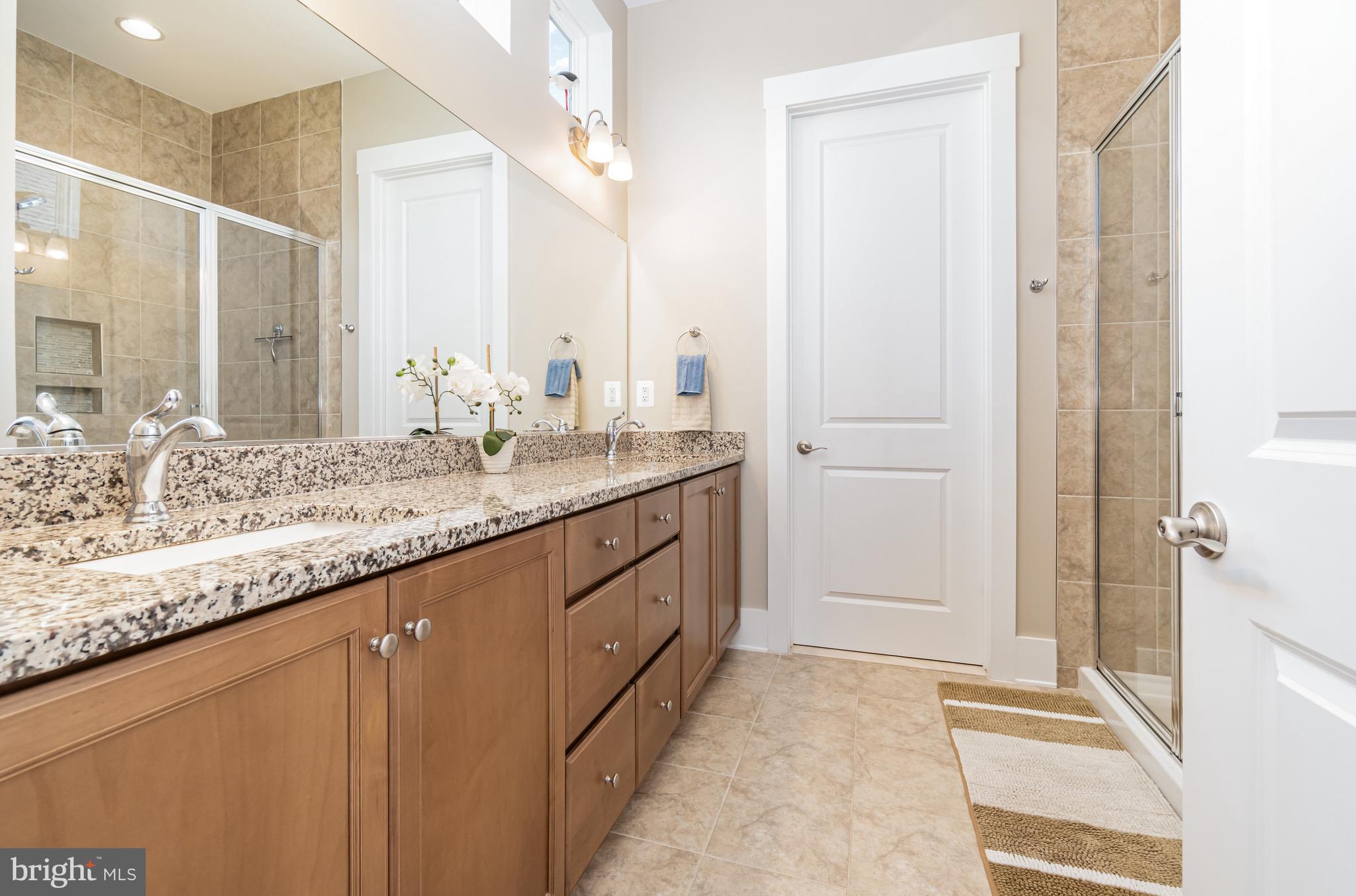 173 Lively Stream Way Gettysburg, PA 17325 - Photo 21 of 59 a bathroom with a granite countertop sink and a mirror