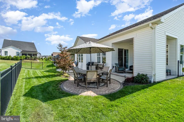 a living room with furniture a fireplace and a chandelier