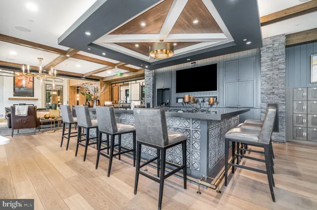 a view of a dining hall with furniture and a kitchen view