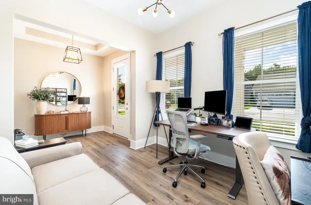 a living room with furniture ceiling fan and a window