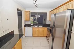 a kitchen with a refrigerator and a sink