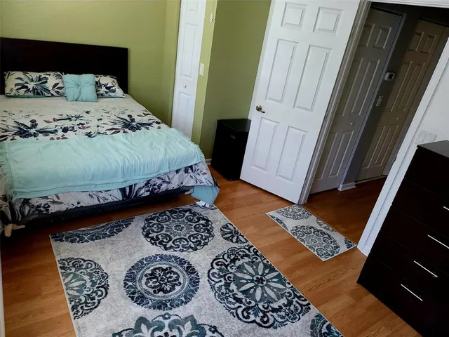 a bed sitting in a bedroom next to a window