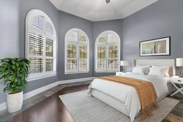 a spacious bedroom with bed and a window