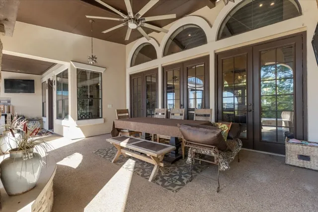 a living room with furniture ceiling fan and a large window