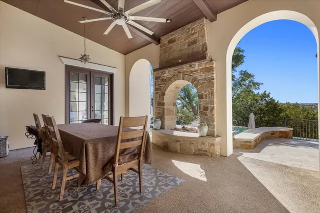 a dining room with furniture a flat screen tv and a floor to ceiling window