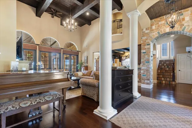 a living room with furniture and a chandelier