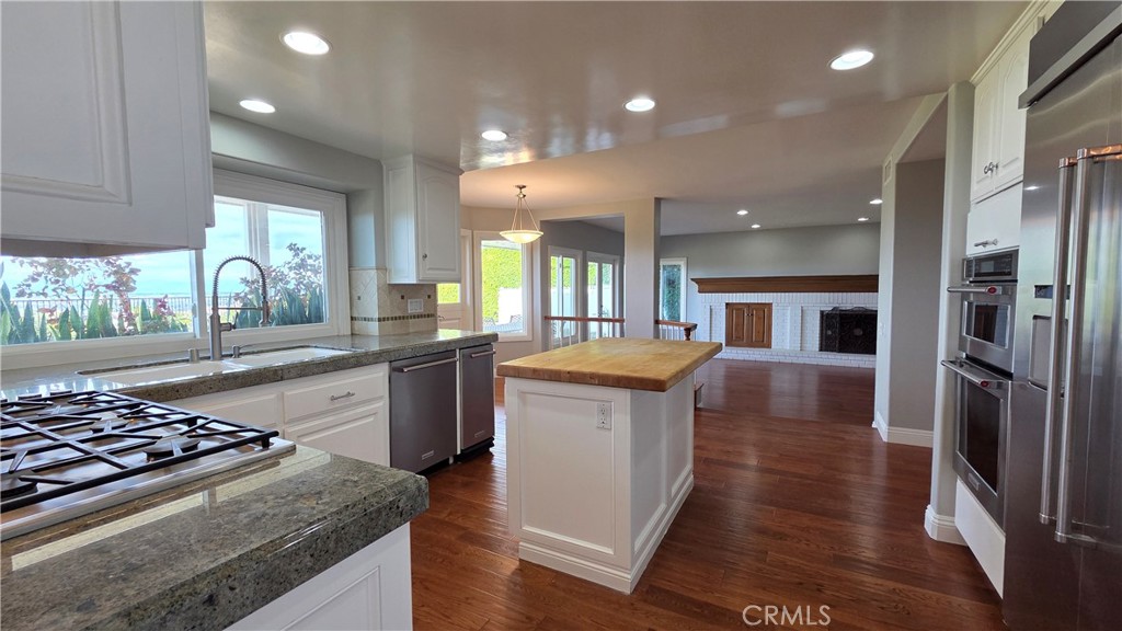 8 Miranda Irvine, CA 92603 - Photo 12 of 32 a large kitchen with stainless steel appliances granite countertop a stove and a refrigerator