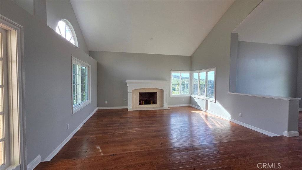 8 Miranda Irvine, CA 92603 - Photo 17 of 32 an empty room with wooden floor fireplace and windows