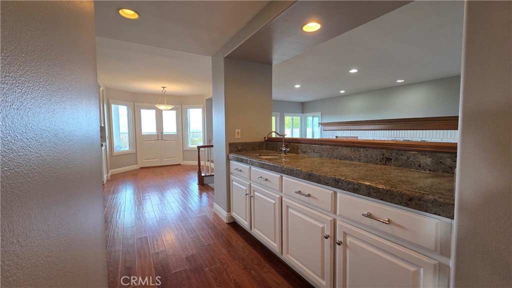 8 Miranda Irvine, CA 92603 - Photo 19 of 32 a view of a kitchen cabinets and center counter space with wooden floor