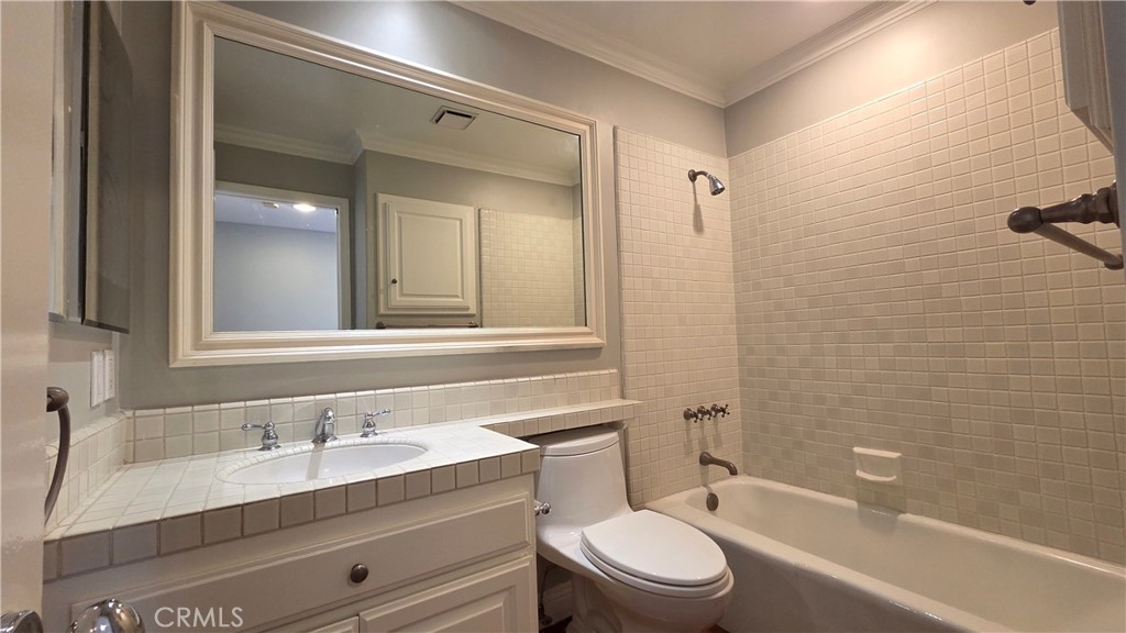 8 Miranda Irvine, CA 92603 - Photo 20 of 32 a bathroom with a granite countertop toilet a sink and a bathtub