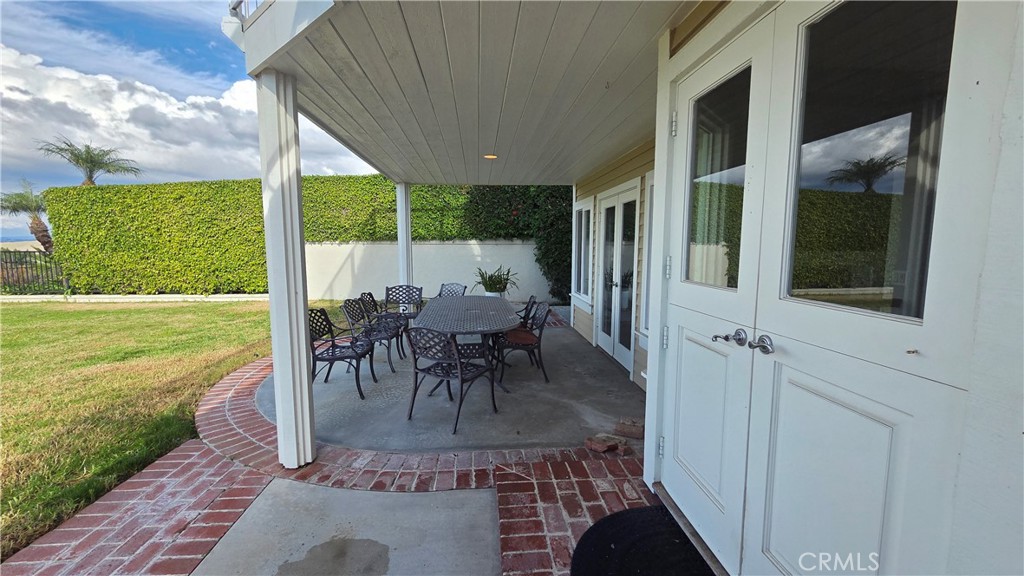 8 Miranda Irvine, CA 92603 - Photo 29 of 32 a view of a patio with table and chairs potted plants with wooden floor and fence