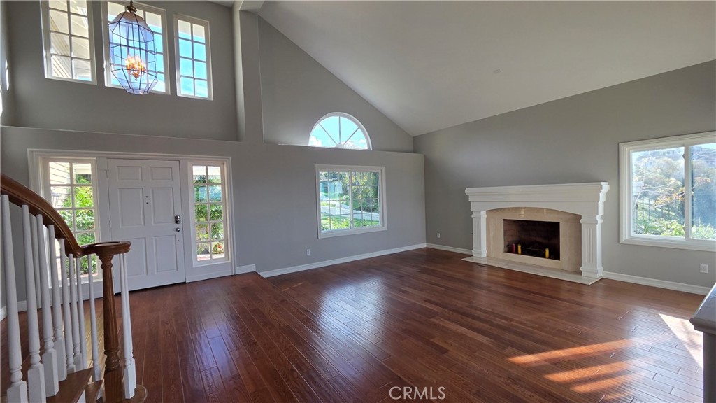 8 Miranda Irvine, CA 92603 - Photo 8 of 32 an empty room with wooden floor fireplace and windows