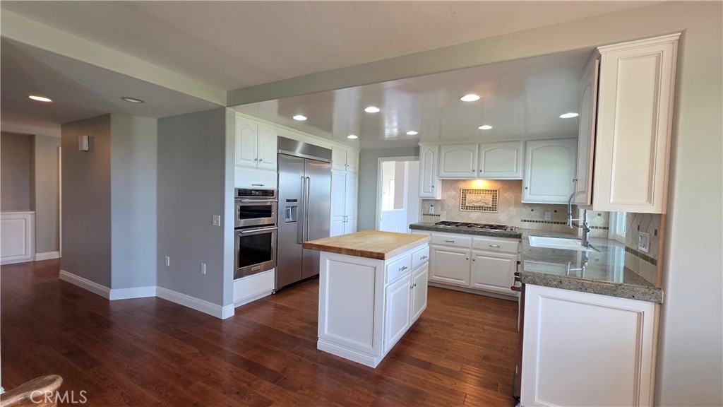 8 Miranda Irvine, CA 92603 - Photo 10 of 32 a kitchen with stainless steel appliances granite countertop a stove top oven a sink and a refrigerator