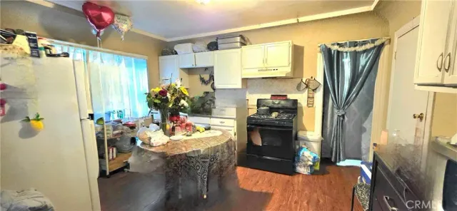 a kitchen with a refrigerator and a stove