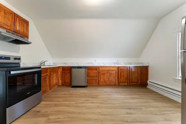 a kitchen with stainless steel appliances granite countertop a stove a sink and a microwave