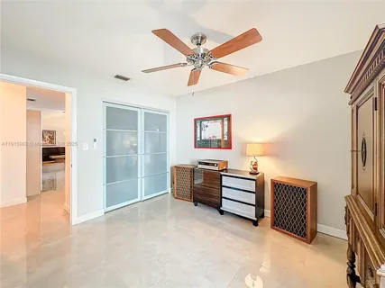 a view of a livingroom with furniture and a ceiling fan