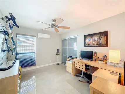 a workspace with furniture and ceiling fan
