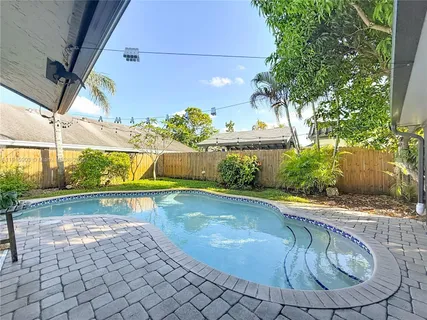 a view of a swimming pool with a patio