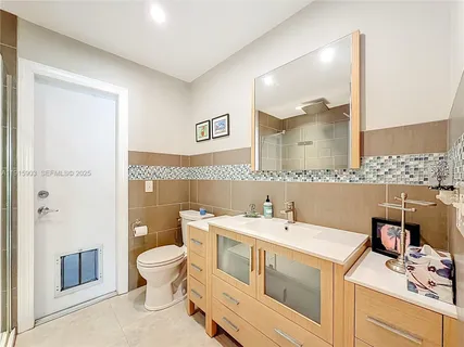 a bathroom with a sink a toilet and mirror