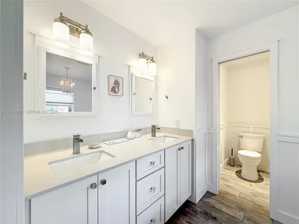 a bathroom with a sink toilet and a mirror