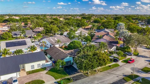 an aerial view of residential houses with outdoor space and street view