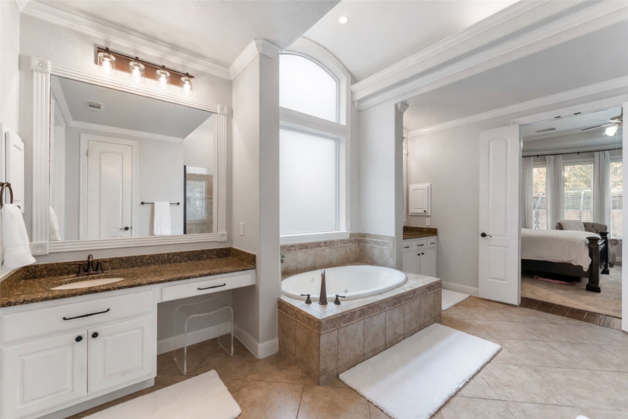 6 Lagato Place Spring, TX 77382 - Photo 21 of 42 The primary bath offers a spa-inspired layout with soaking tub, oversized vanity, and abundant natural light. Neutral finishes and generous proportions create a calming retreat.
