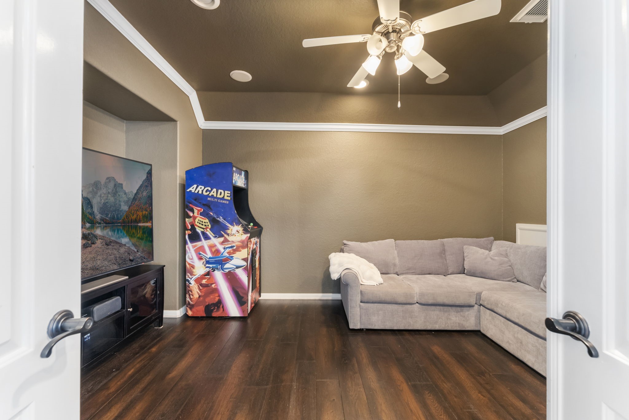 6 Lagato Place Spring, TX 77382 - Photo 25 of 42 A dedicated media room provides a cozy, enclosed space perfect for movie nights or gaming. Darker tones and crown molding enhance the theater-like feel.