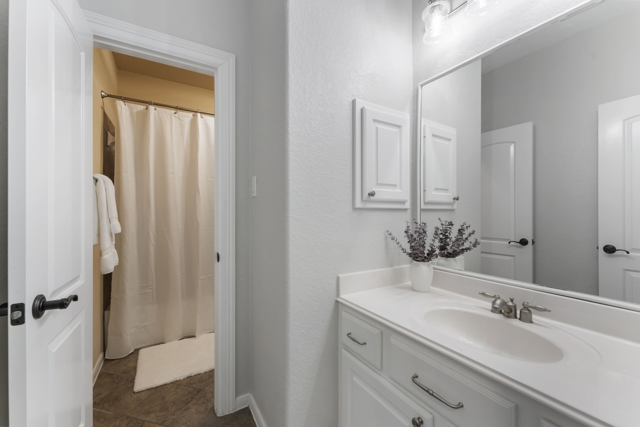 6 Lagato Place Spring, TX 77382 - Photo 30 of 42 This vanity view highlights generous counter space, storage cabinetry, and updated lighting. Neutral finishes keep the space timeless and fresh.