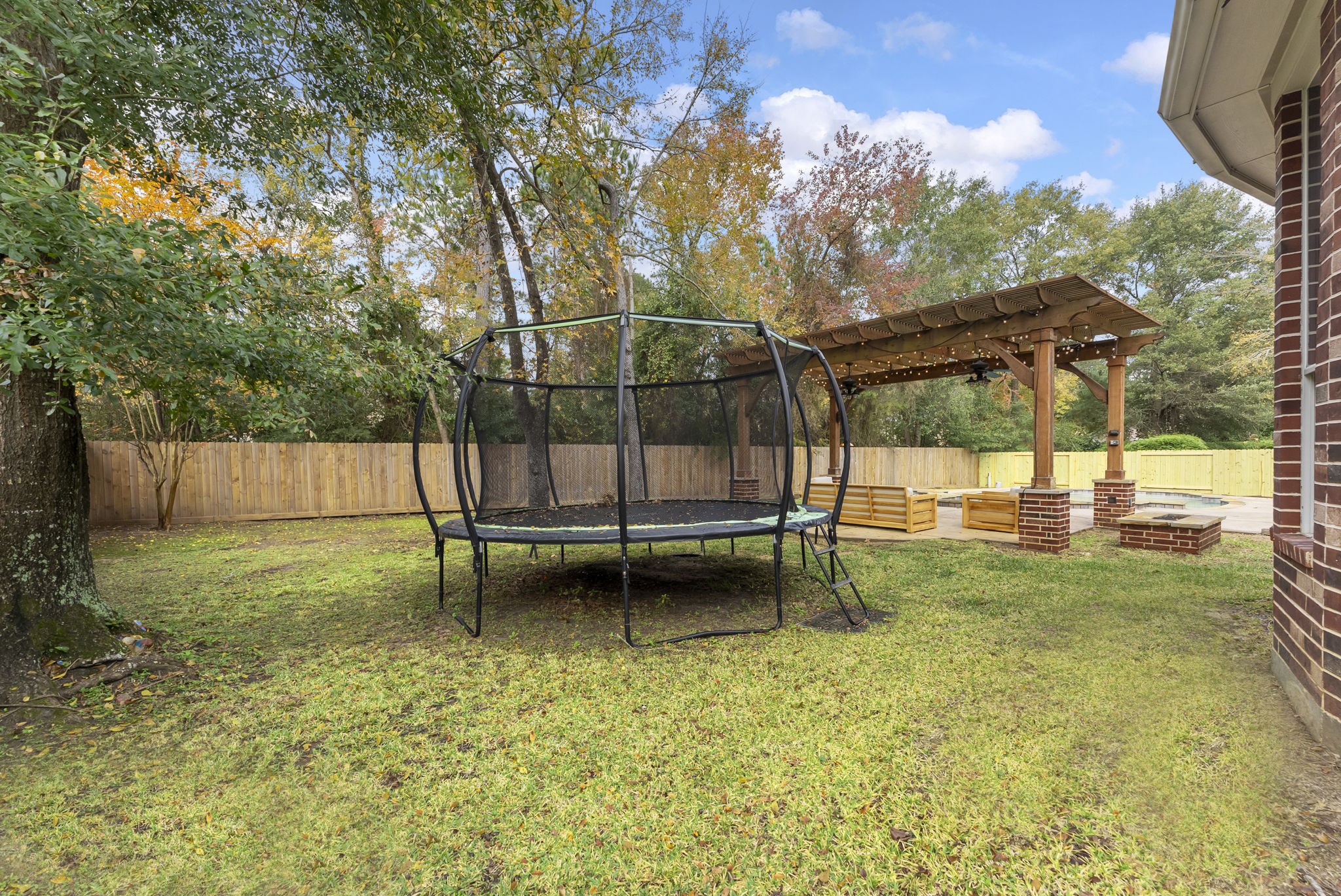 6 Lagato Place Spring, TX 77382 - Photo 38 of 42 A freeform pool with tanning ledge and surrounding patio creates a true backyard retreat. Designed for both relaxation and fun, with plenty of room for loungers and gatherings.