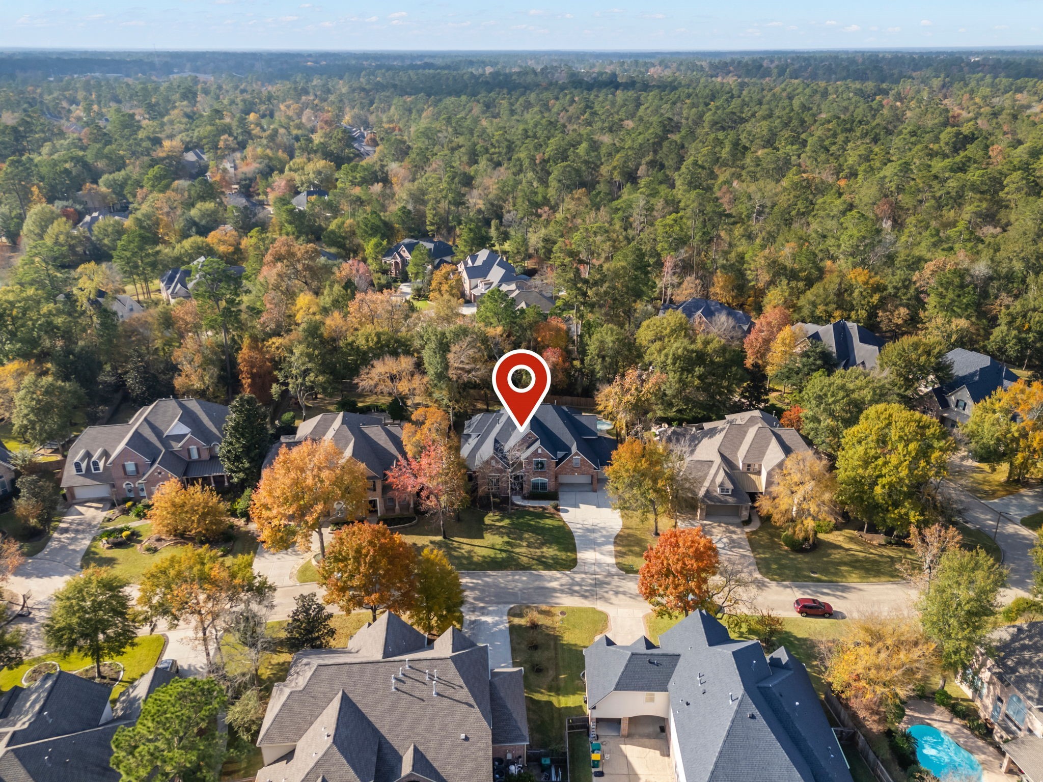 6 Lagato Place Spring, TX 77382 - Photo 39 of 42 An aerial perspective highlights the home’s setting within a quiet, tree-lined neighborhood surrounded by mature foliage. Positioned on a peaceful street with generous spacing between homes.