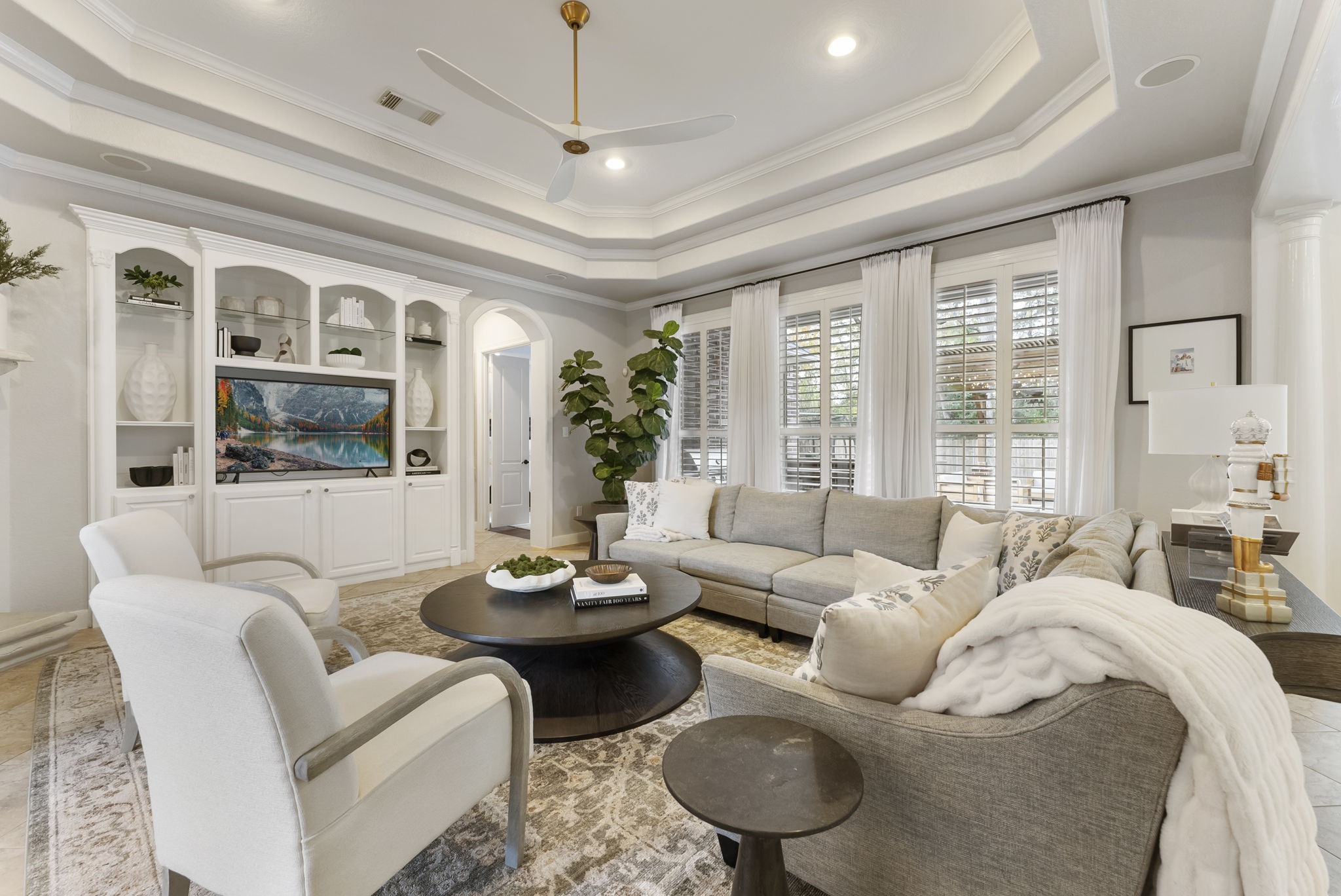 6 Lagato Place Spring, TX 77382 - Photo 9 of 42 This comfortable seating arrangement highlights the room’s generous scale and natural light. Plantation shutters and soft finishes create a calm, inviting atmosphere.