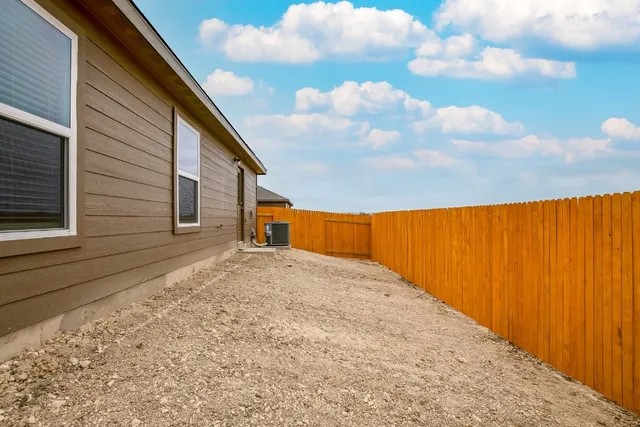 a backyard of a house with wooden fence