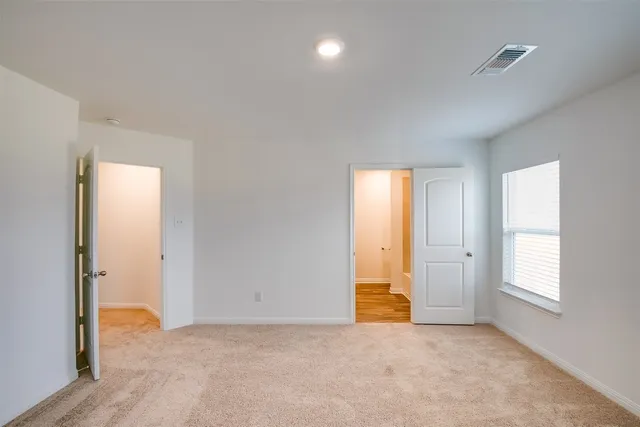 an empty room with windows and closet