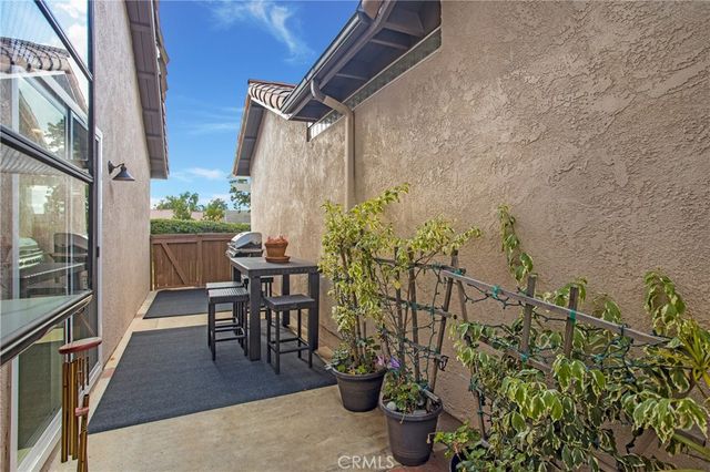 a view of a patio with table and chairs and potted plants