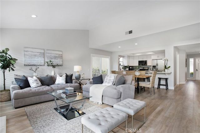 a living room with furniture wooden floor and a table