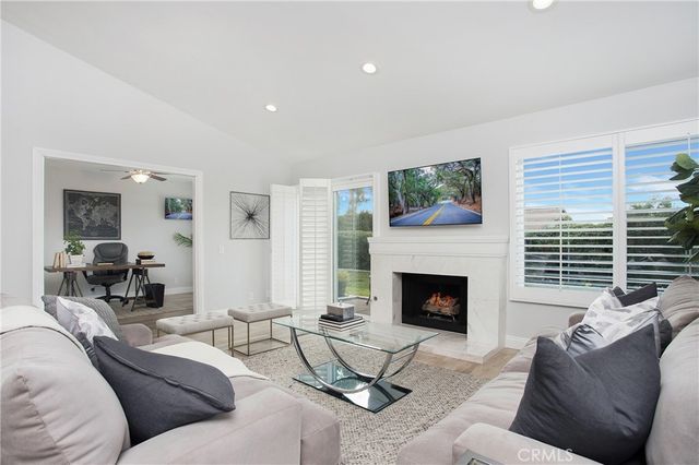 a living room with furniture fireplace and window