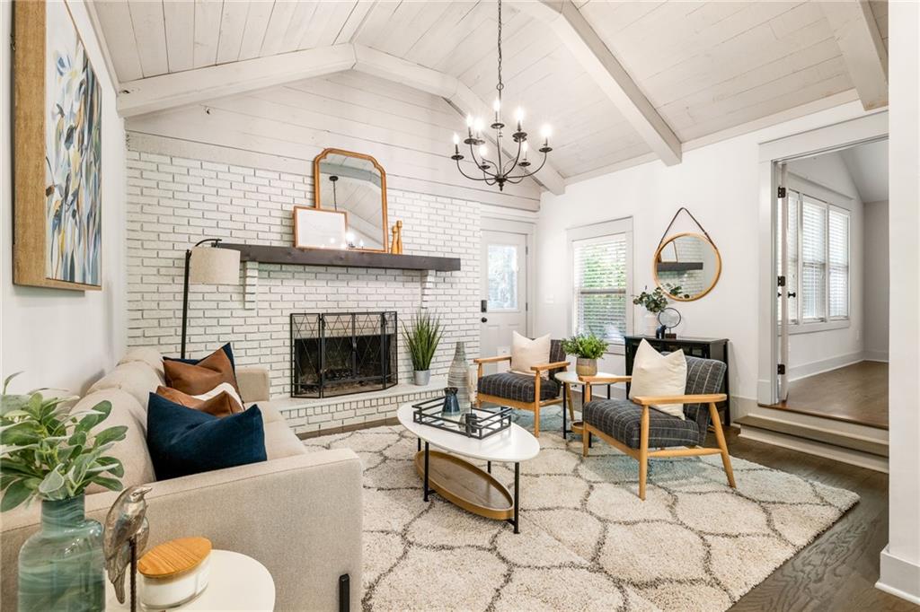 1002 Forrest Boulevard Decatur, GA 30030 - Photo 1 of 1 a living room with furniture chandelier and a fireplace