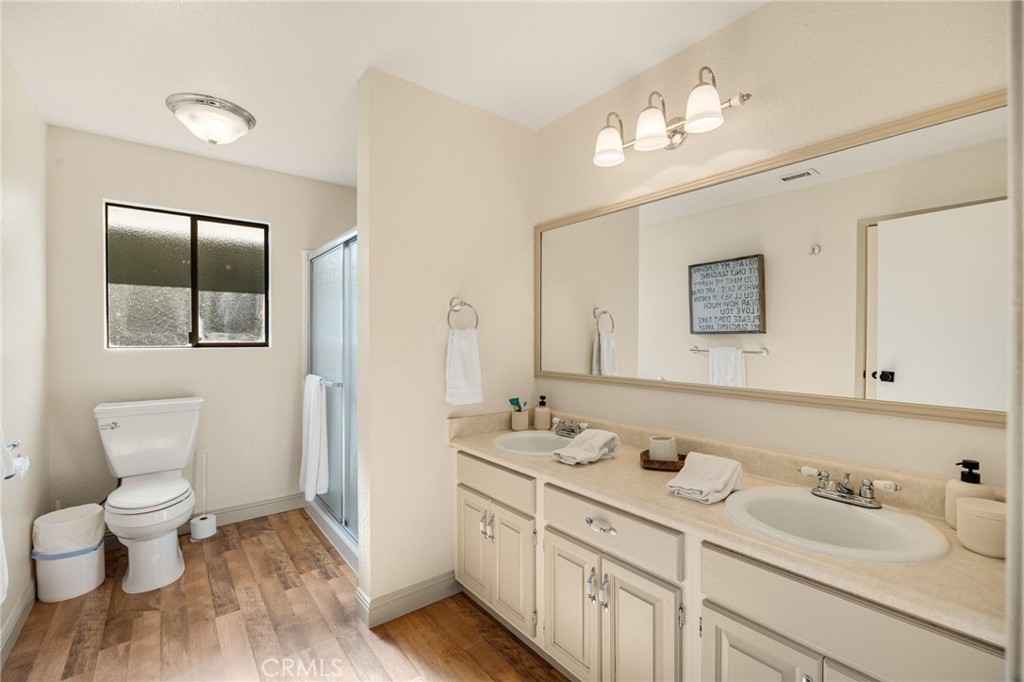 48980 De Luz Road Temecula, CA 92590 - Photo 21 of 50 a bathroom with a toilet sink and mirror